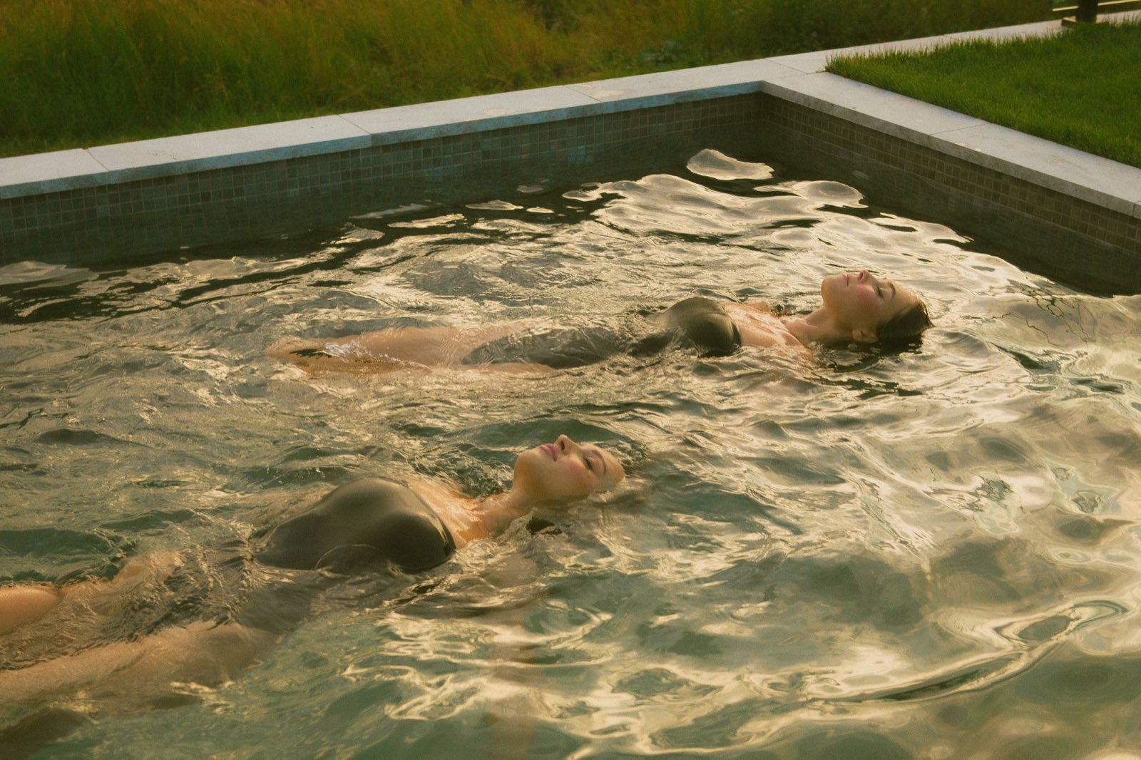 Shanti Griffin floating in a pool at golden hour, editorial frame
